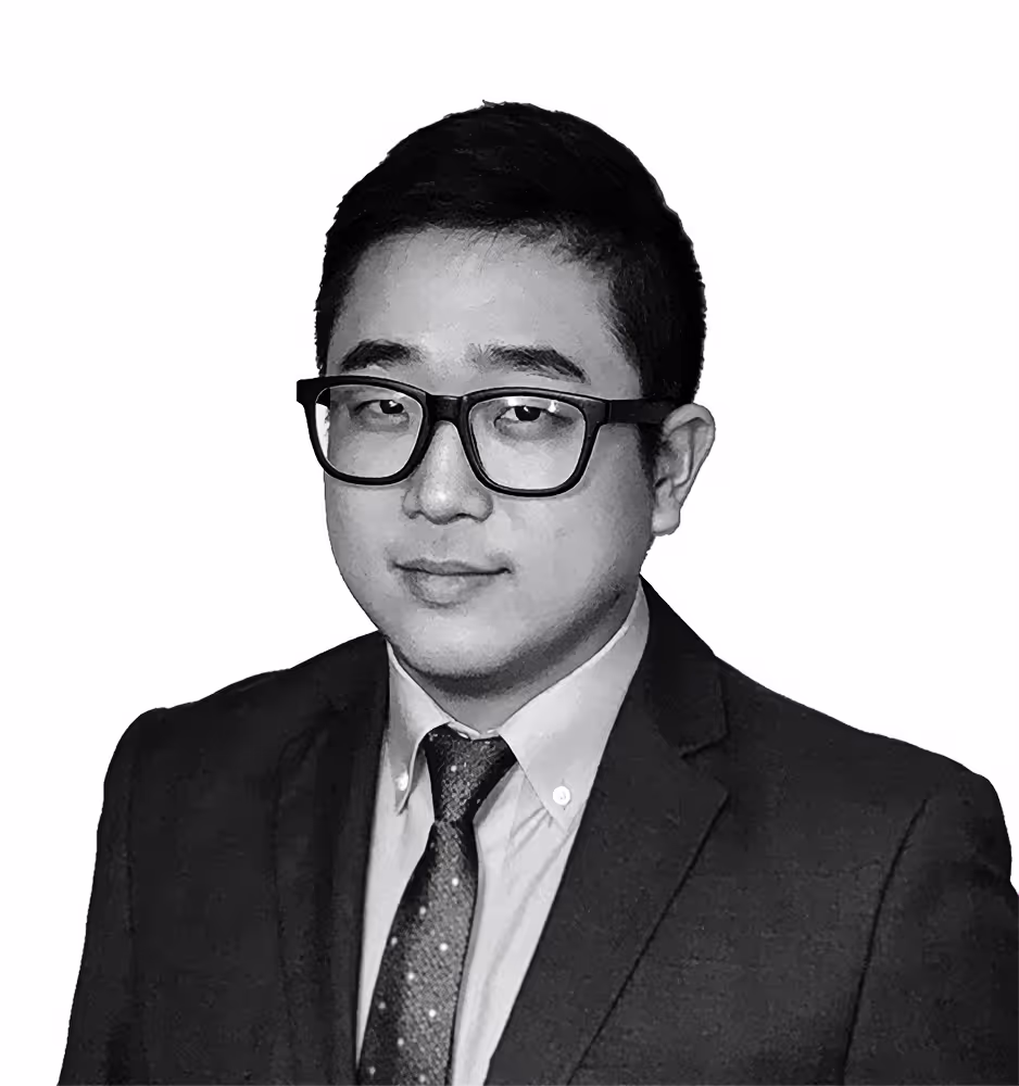 Black and white portrait of Nathan S. Yun, a professional attorney dressed in a tailored suit, exuding a composed and authoritative demeanor.