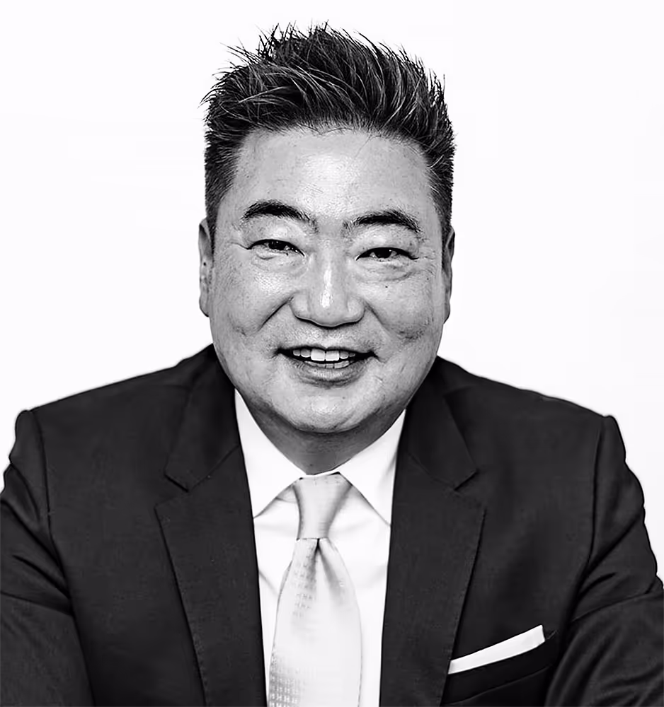 Black and white portrait of Thomas J. Ryu, a professional attorney dressed in a formal suit, conveying a poised and authoritative demeanor.
