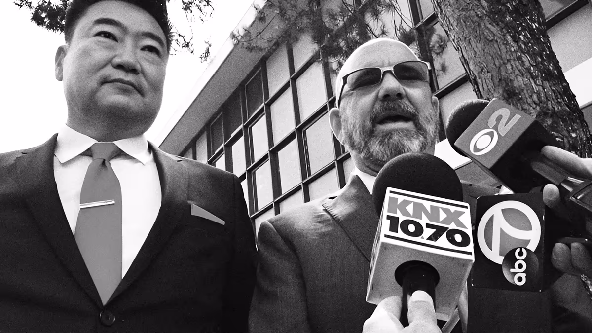 Attorney Thomas J. Ryu faces a crowd of microphones outside the courthouse during the Mehringer Trials.
