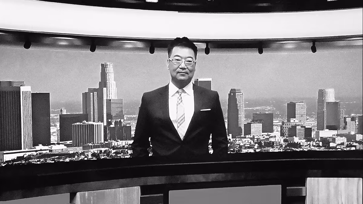 Attorney Thomas J. Ryu prepares for a live broadcast in a newsroom studio.