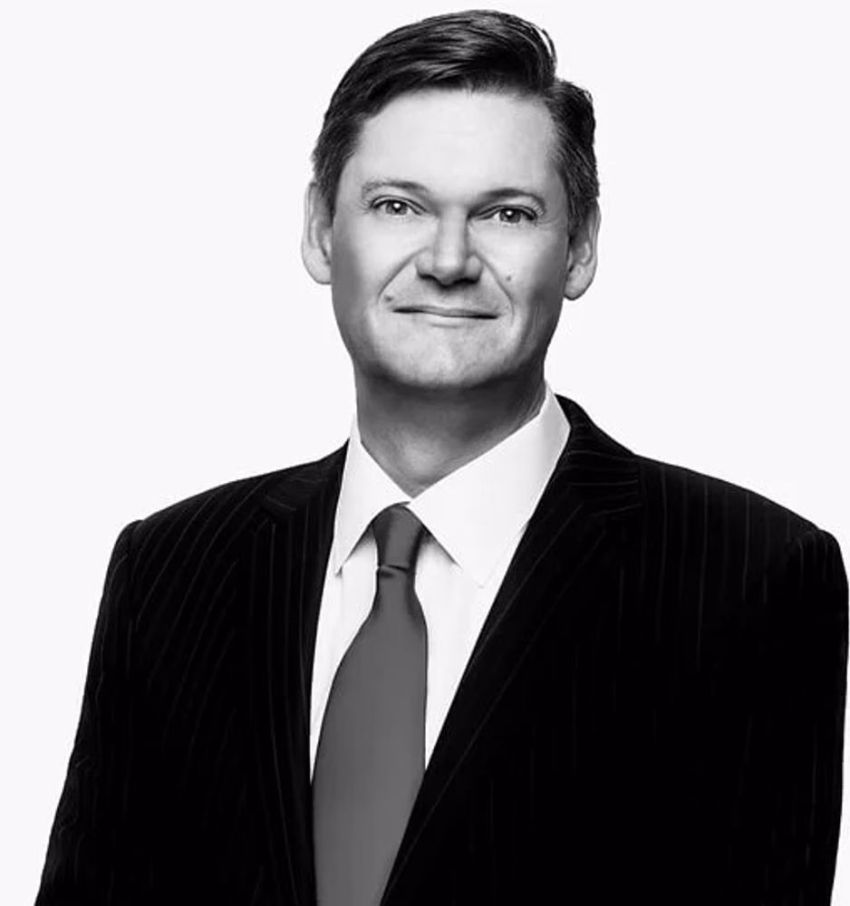 Black and white portrait of Mark J. Haushalter, Of Counsel, in a pinstriped suit.