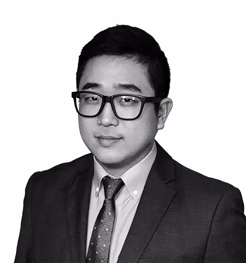 Black and white portrait of Nathan S. Yun, a professional attorney dressed in a tailored suit, exuding a composed and authoritative demeanor.