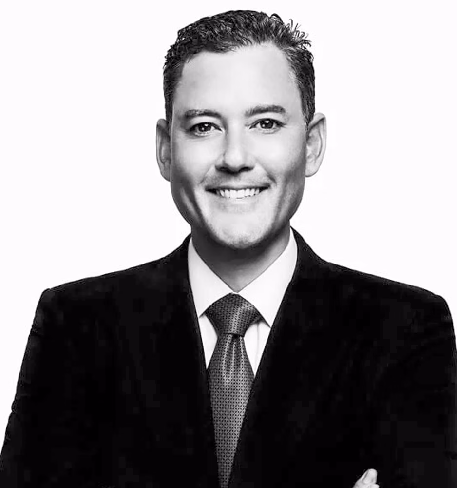 Black and white portrait of Ryan T. Okabe, Of Counsel, in a dark suit.