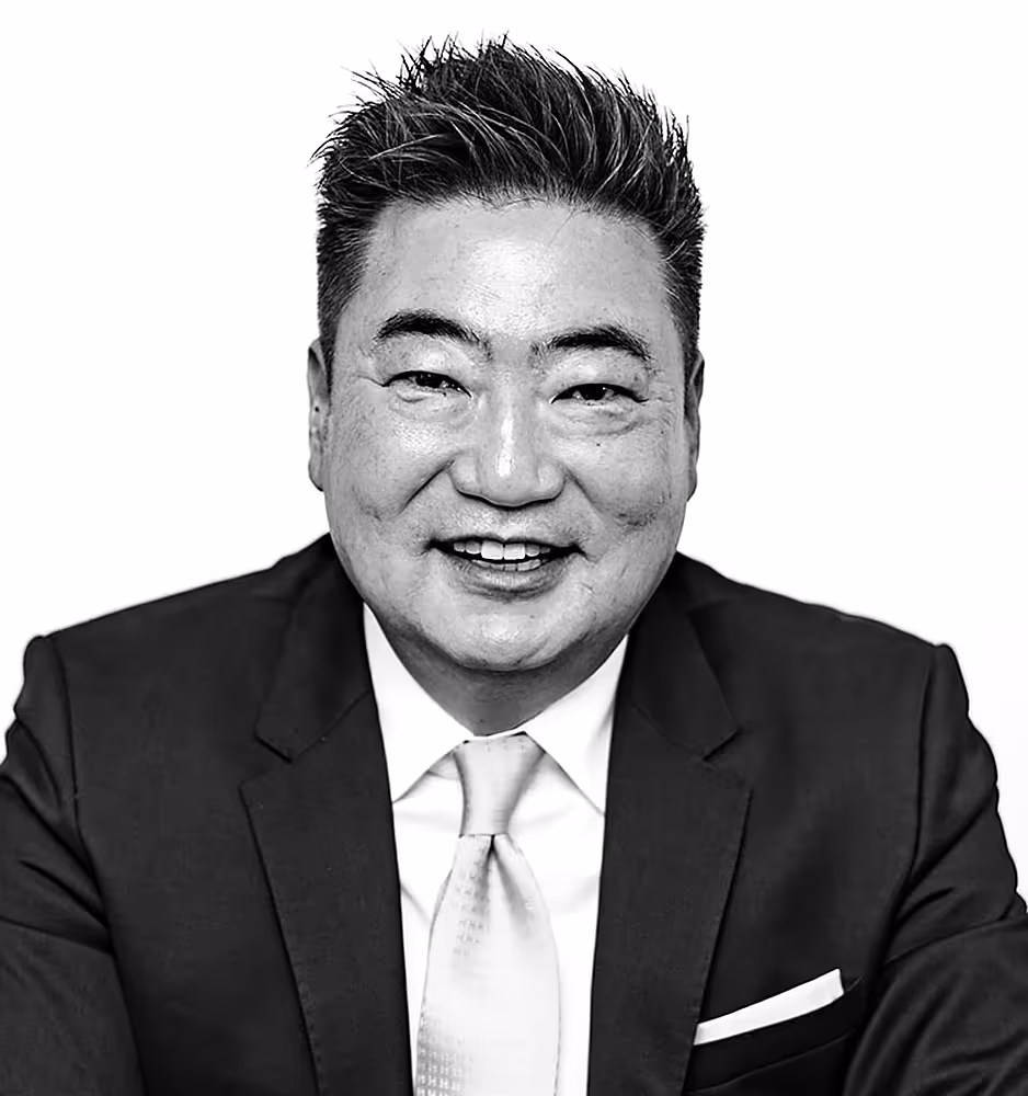 Black and white portrait of Thomas J. Ryu, a professional attorney dressed in a formal suit, conveying a poised and authoritative demeanor.